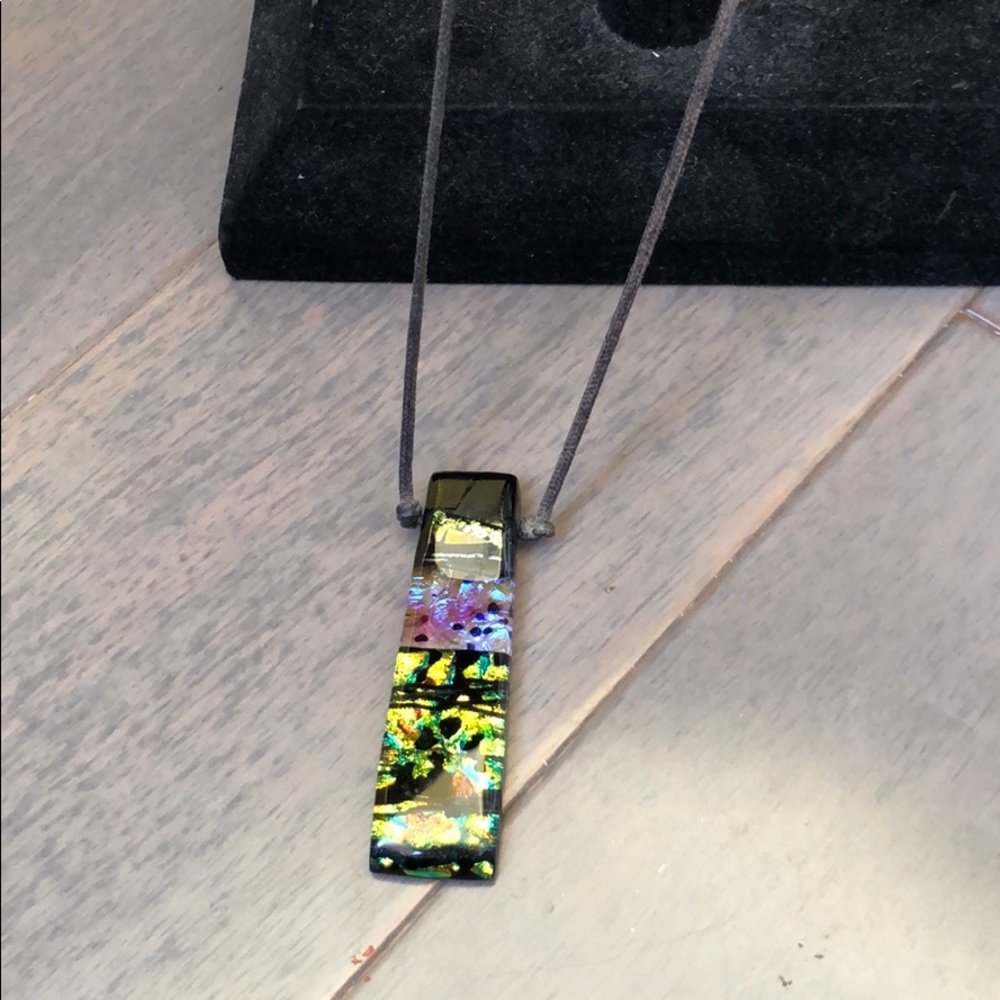 Pendant necklace on rope chain.